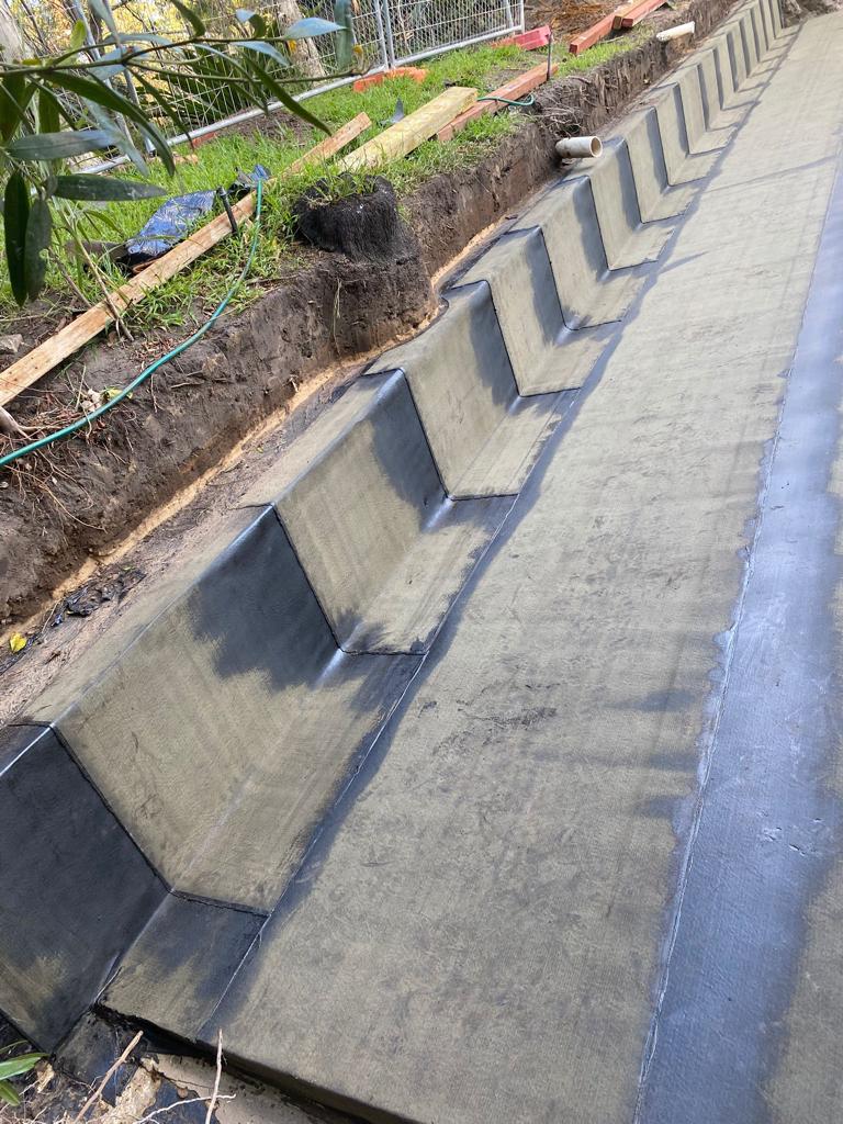 Freshly constructed drainage channel with concrete lining.