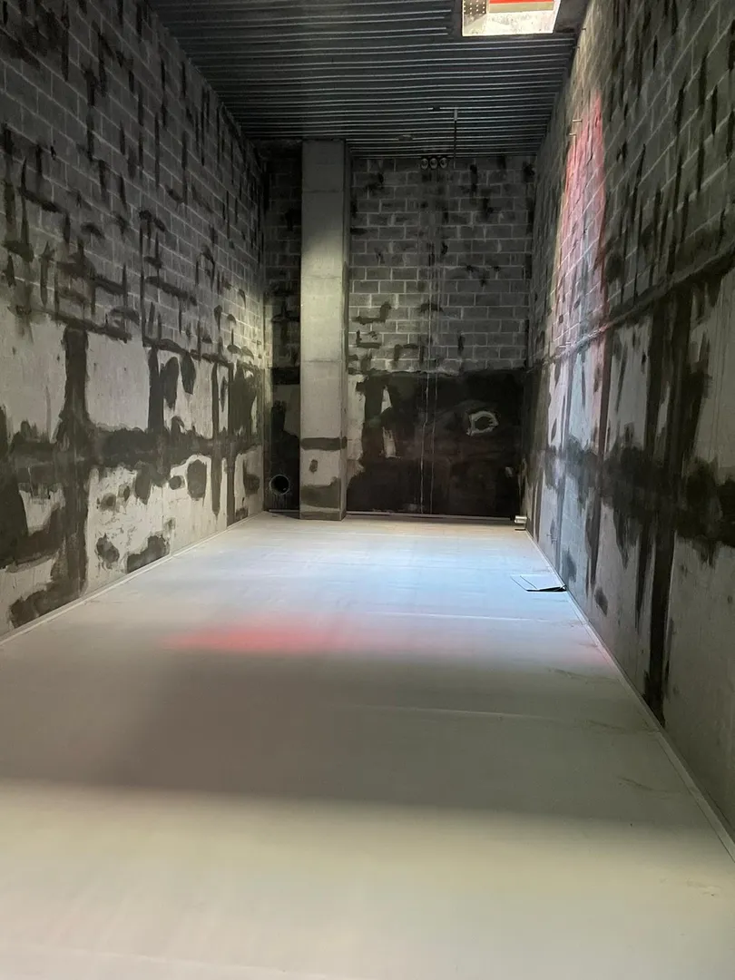 Empty unfinished industrial room with concrete walls.