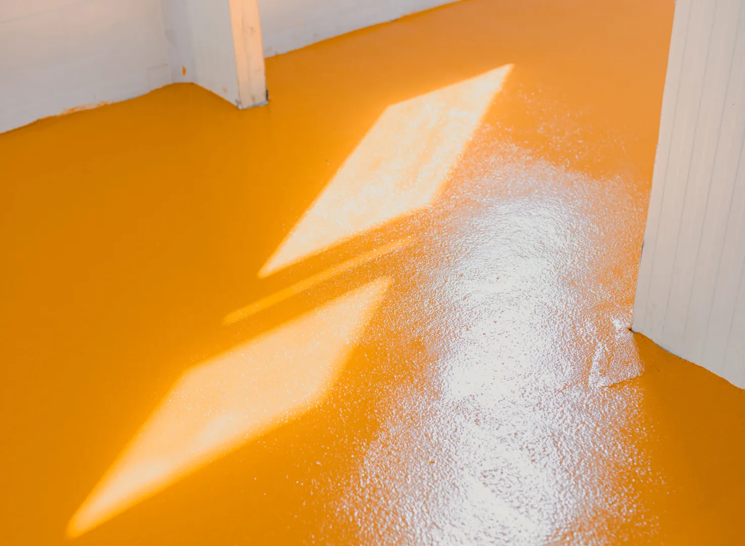 Orange floor with sunlight reflections
