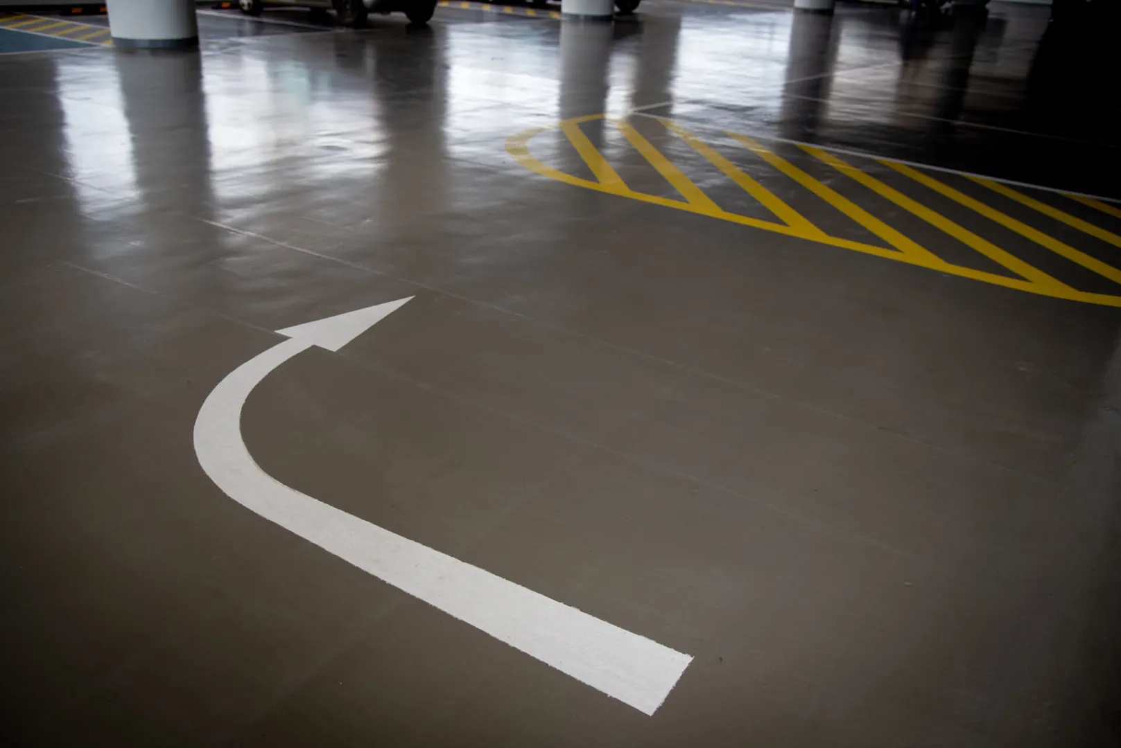 Parking garage with arrow and caution lines